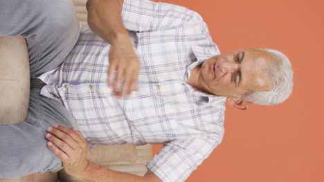 Vertical-video-of-Man-looking-negative-at-camera.